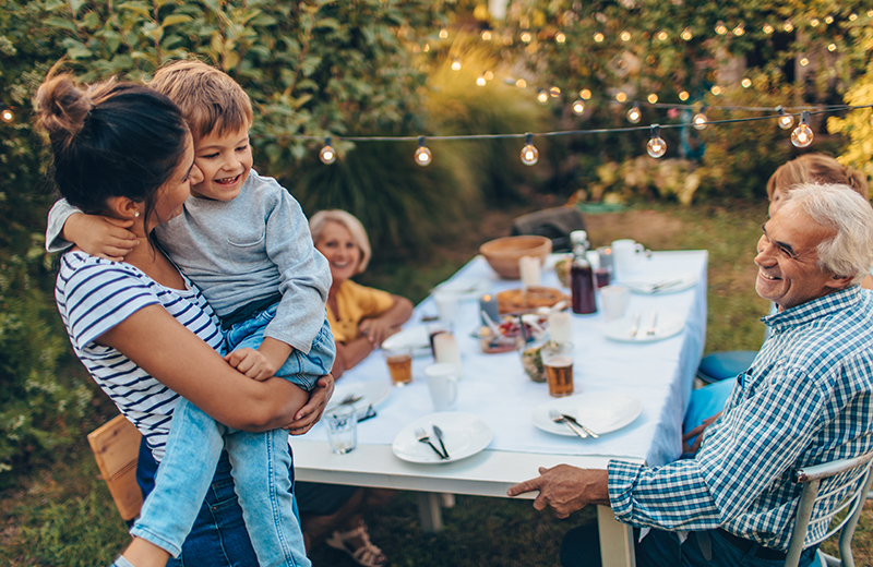 Family eating in the garden at an Edgefold Homes development